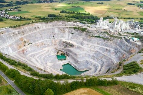 The view from above into a quarry with a processing plant.